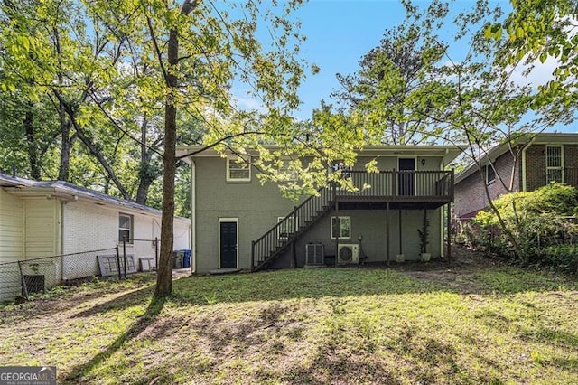 back of house with a deck, fence, stairs, central AC unit, and a lawn