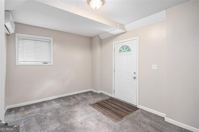 carpeted entrance foyer featuring baseboards and a wall mounted air conditioner