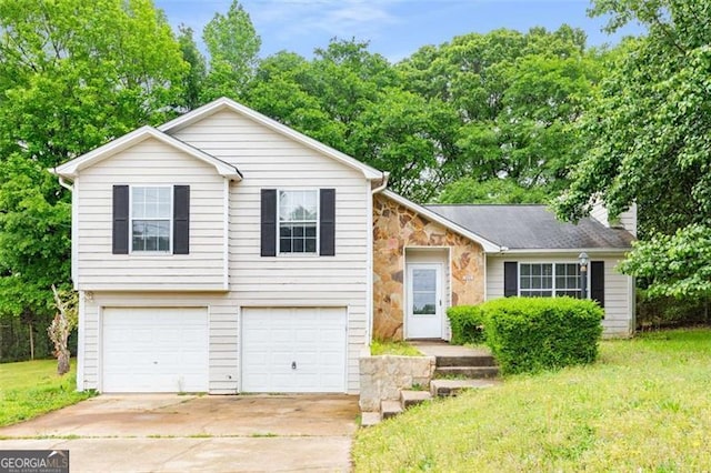402 Leslie Ct, Mcdonough, GA 30253 - tri-level home with an attached garage, concrete driveway, a chimney, stone siding, and a front yard