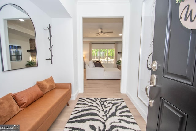 foyer featuring ceiling fan, baseboards, light wood-type flooring, recessed lighting, and ornamental molding