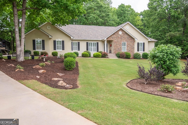 ranch-style house with a shingled roof, a front lawn, stucco siding, and stone siding