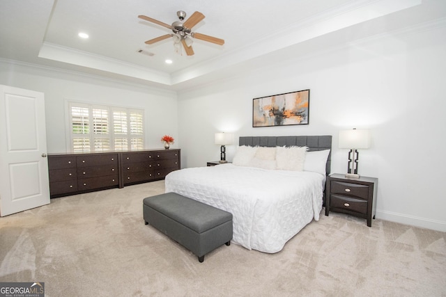 bedroom featuring crown molding, a raised ceiling, visible vents, and carpet floors