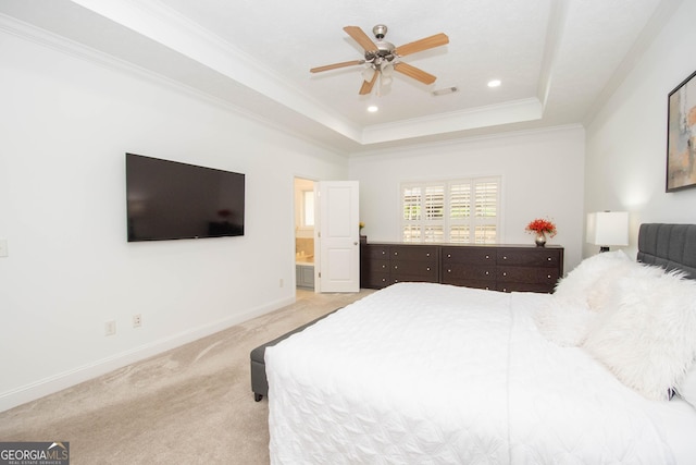bedroom with a tray ceiling, crown molding, visible vents, light carpet, and baseboards