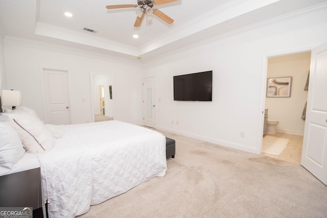 carpeted bedroom with crown molding, visible vents, ensuite bathroom, a tray ceiling, and recessed lighting