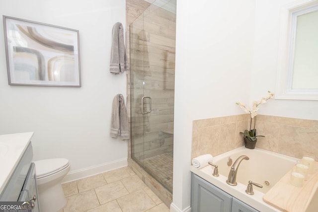 bathroom featuring tile patterned flooring, a stall shower, a jetted tub, and vanity
