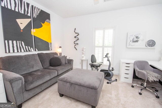 carpeted living room with visible vents and baseboards