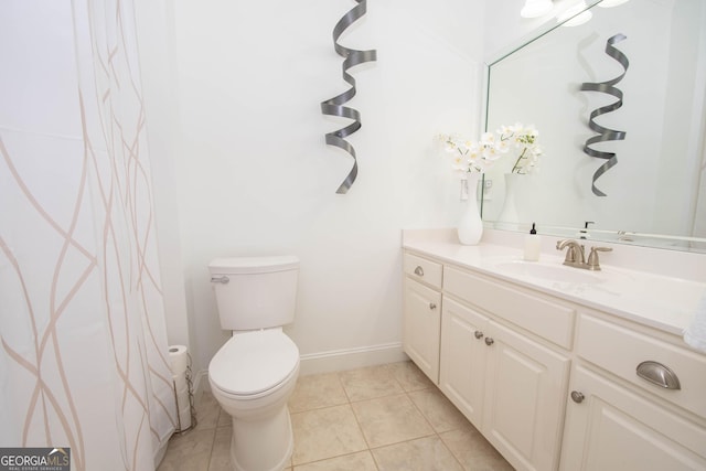 full bathroom featuring baseboards, tile patterned floors, toilet, and vanity