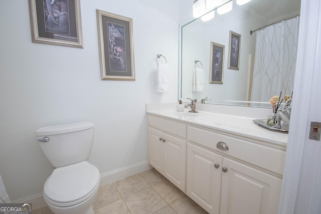 bathroom featuring vanity, toilet, tile patterned flooring, and baseboards