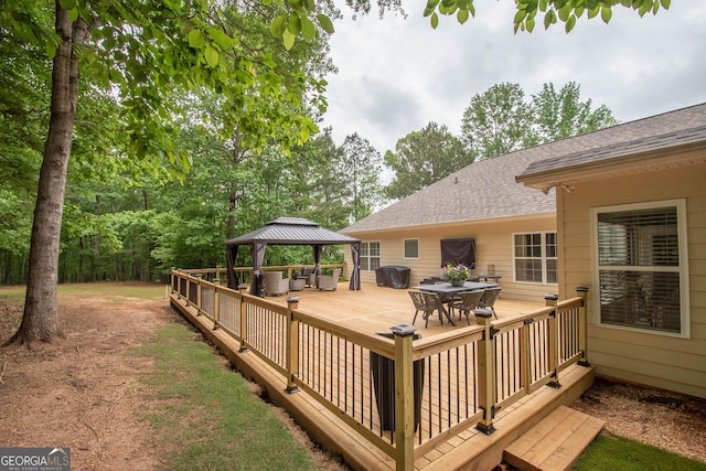 deck featuring a gazebo and outdoor dining space