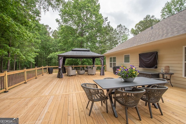 wooden deck with a gazebo, an outdoor hangout area, and outdoor dining area