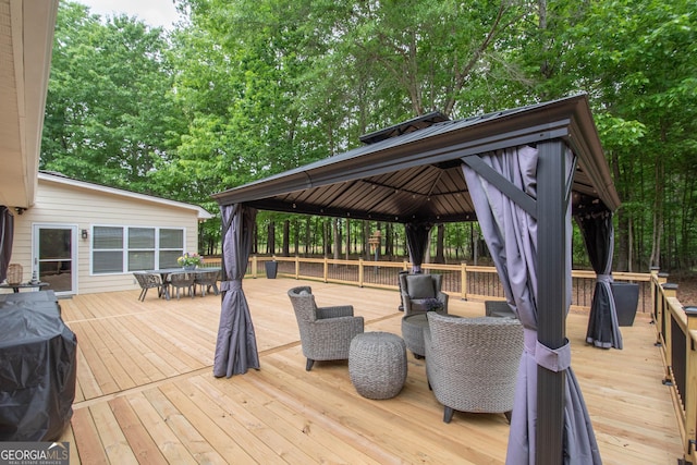 deck featuring outdoor dining space and a gazebo