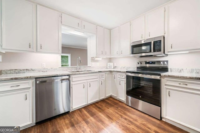 kitchen with a sink, appliances with stainless steel finishes, and white cabinetry