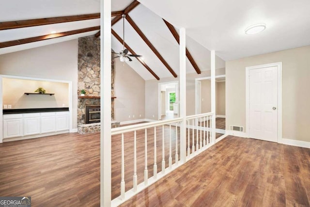 additional living space featuring visible vents, beam ceiling, and wood finished floors