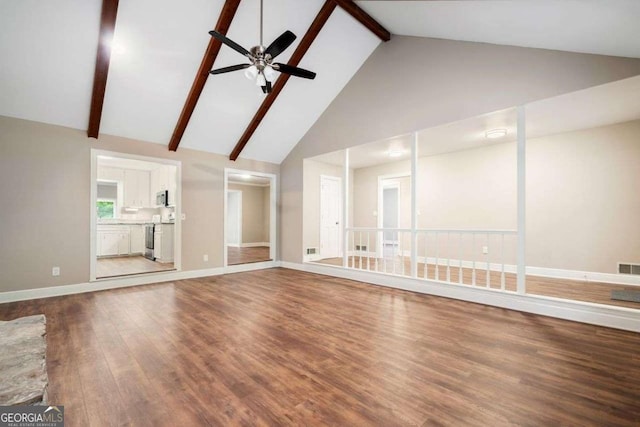 unfurnished living room featuring baseboards, wood finished floors, beam ceiling, high vaulted ceiling, and a ceiling fan