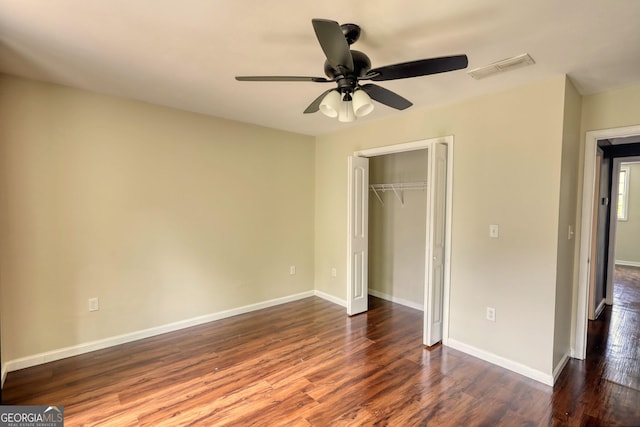 unfurnished bedroom featuring visible vents, baseboards, and wood finished floors
