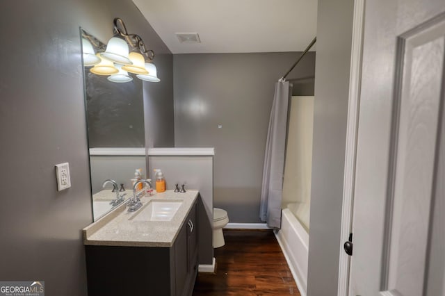 bathroom featuring vanity, visible vents, an inviting chandelier, wood finished floors, and toilet