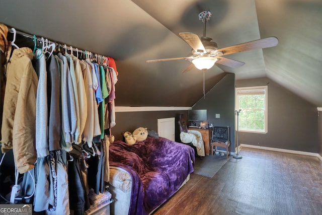 bedroom with baseboards, ceiling fan, wood finished floors, and vaulted ceiling
