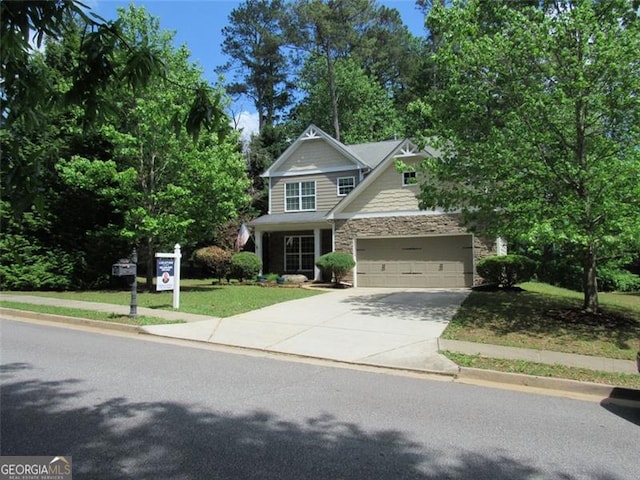 craftsman inspired home featuring a garage, driveway, a front lawn, and stone siding