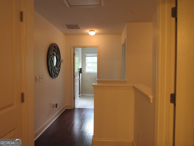 hallway with baseboards, dark wood finished floors, and visible vents