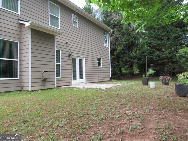 back of house with a yard and a patio area