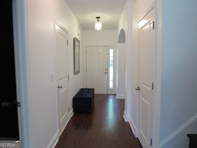 entryway with baseboards and dark wood-style flooring