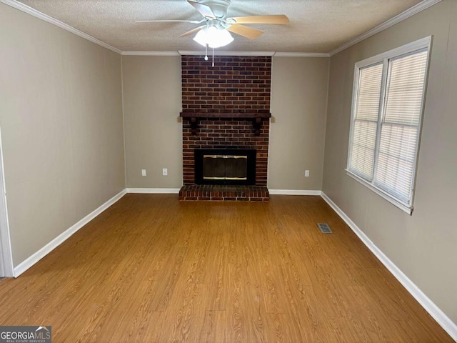 unfurnished living room with ornamental molding, a textured ceiling, ceiling fan, and wood finished floors