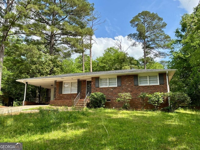 ranch-style home featuring driveway, a carport, a front yard, and brick siding