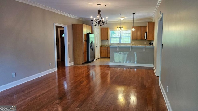 350 Wood Lake Dr Unit 13, Athens, GA 30606 - kitchen featuring brown cabinets, stainless steel fridge, a notable chandelier, a peninsula, and wood finished floors