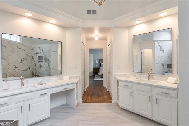 full bathroom featuring visible vents, a sink, crown molding, and two vanities