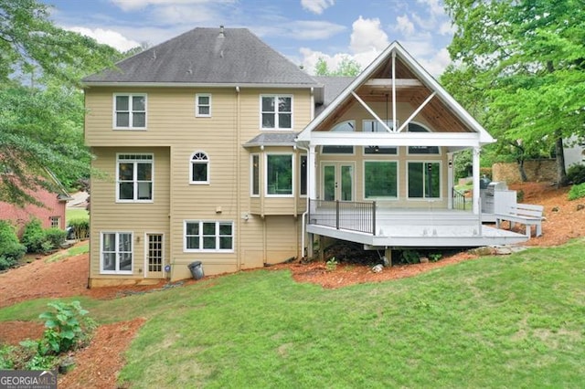 back of house with french doors, a yard, and a deck