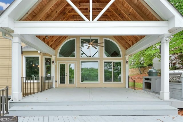 exterior space with a deck, french doors, and a grill