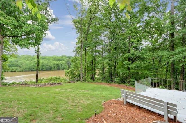 view of yard featuring a water view and a view of trees