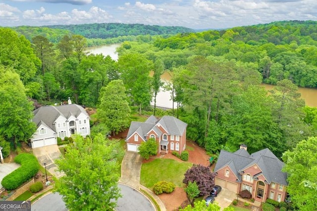 drone / aerial view featuring a water view and a view of trees