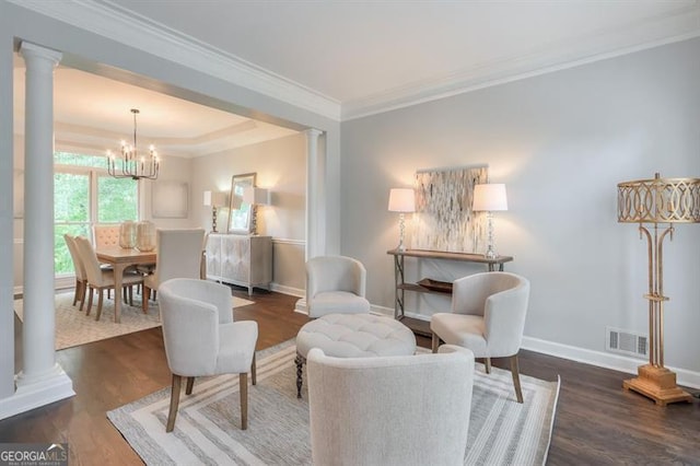 sitting room featuring visible vents, an inviting chandelier, decorative columns, baseboards, and dark wood-type flooring
