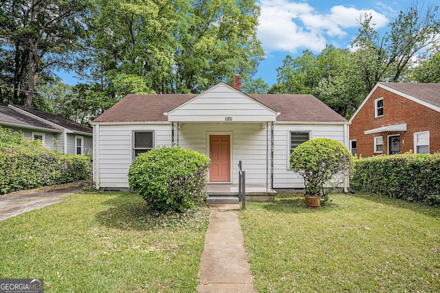 2447 Crestview Ave, Decatur, GA 30032 - bungalow-style home featuring a chimney, a front lawn, crawl space, and a shingled roof