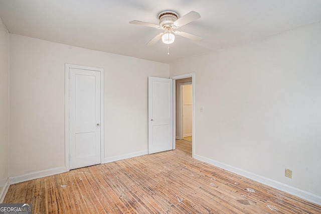 2447 Crestview Ave, Decatur, GA 30032 - unfurnished bedroom with light wood-style floors, baseboards, and a ceiling fan