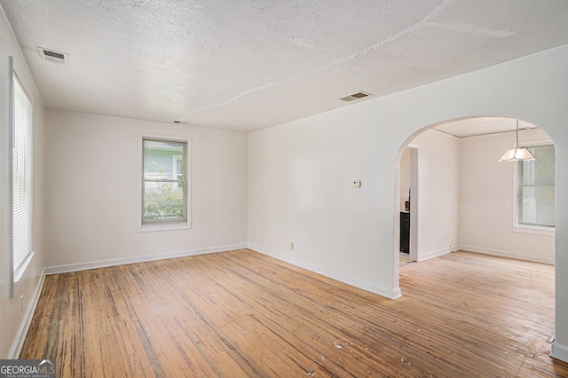 2447 Crestview Ave, Decatur, GA 30032 - spare room featuring hardwood / wood-style flooring, a textured ceiling, arched walkways, and baseboards