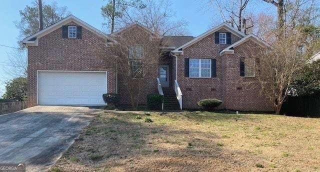 view of front of property featuring a front yard, concrete driveway, a garage, and brick siding