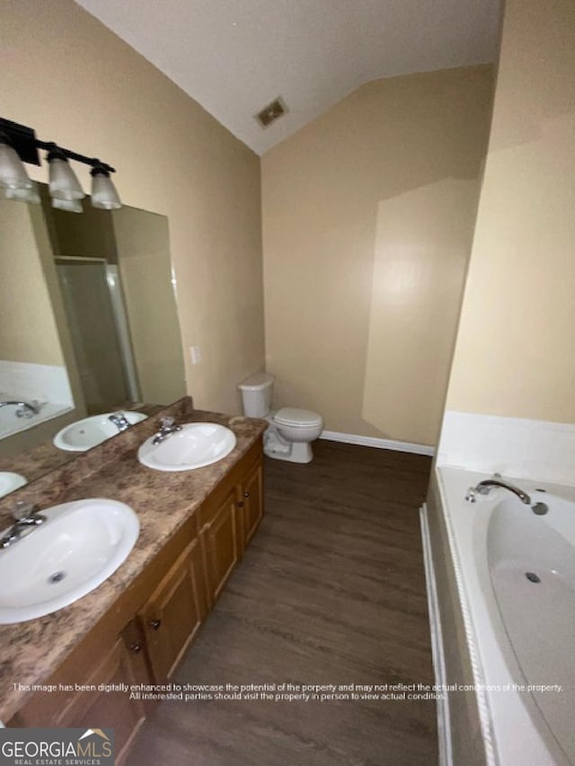 bathroom with double vanity, a sink, and lofted ceiling