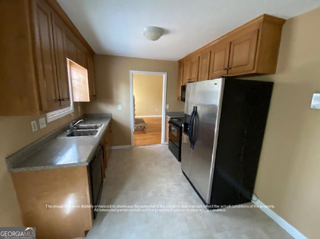 kitchen with a sink, black dishwasher, stove, baseboards, and stainless steel fridge with ice dispenser
