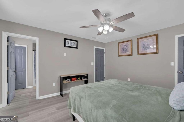 bedroom featuring visible vents, a ceiling fan, light wood finished floors, and baseboards