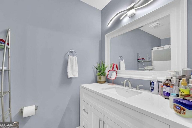 bathroom featuring vanity and vaulted ceiling