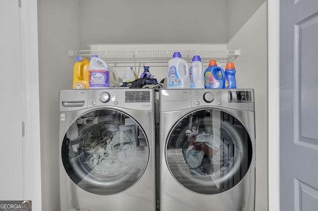 clothes washing area featuring laundry area and washing machine and dryer