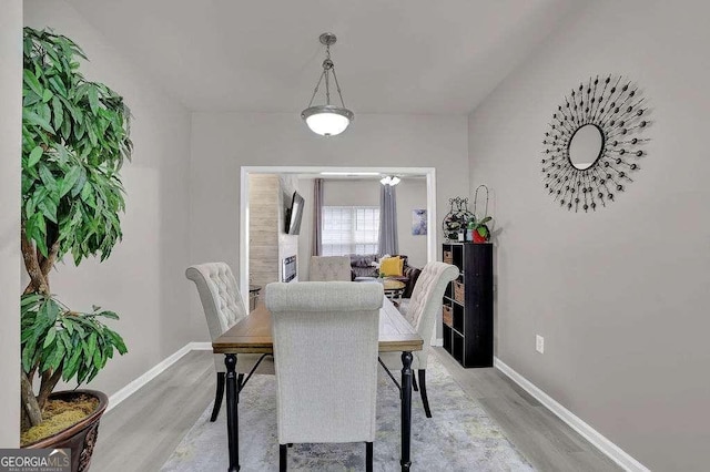dining room with light wood finished floors and baseboards