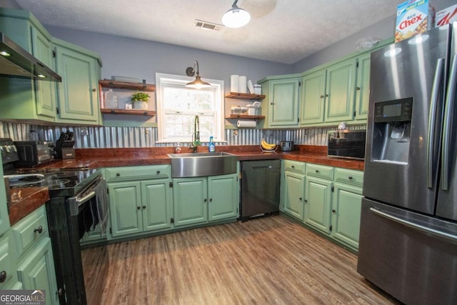 kitchen with open shelves, stainless steel fridge, dishwasher, and a sink