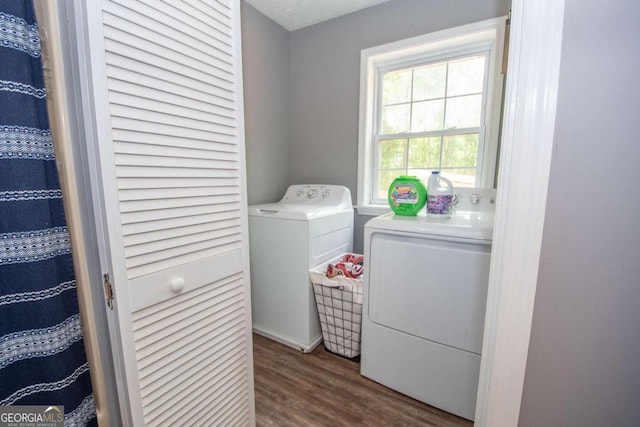 laundry area with dark wood-style floors and separate washer and dryer
