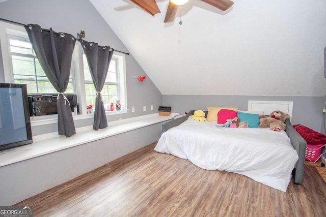 bedroom with wood finished floors, ceiling fan, and vaulted ceiling