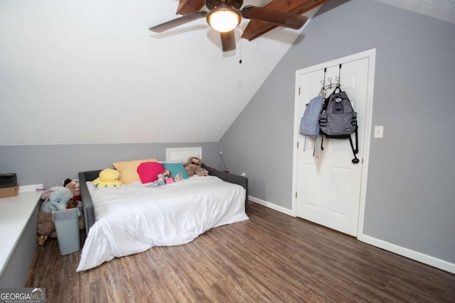 bedroom with baseboards, wood finished floors, ceiling fan, and lofted ceiling