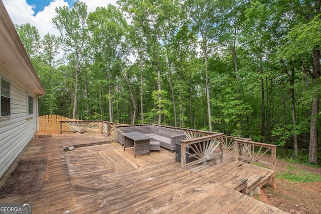 wooden deck featuring a forest view