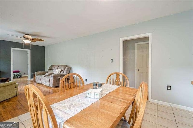 dining area with light tile patterned floors, ceiling fan, and baseboards